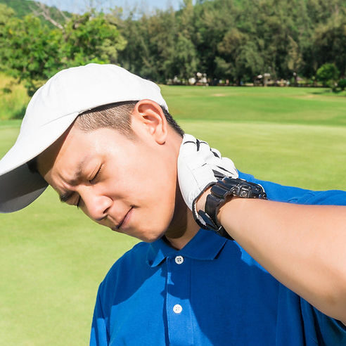 A man is adjusting his neck while playing golf.