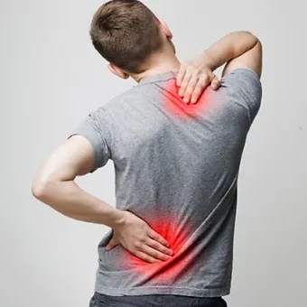 A man with back pain is holding his back.